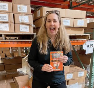 Marijean Oldham in the Reedy Press warehouse in St. Louis with the newly released third edition of 100 Things to Do in Charlottesville Before You Die.